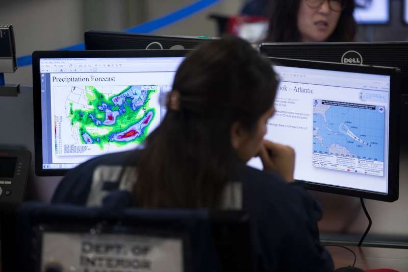 Employees sit in front of computer monitors at the command center of the Federal Emergency Management Agency (FEMA) headquarters, shortly before a visit by U.S. President Donald Trump (not pictured) on August 4, 2017 in Washington, DC.
