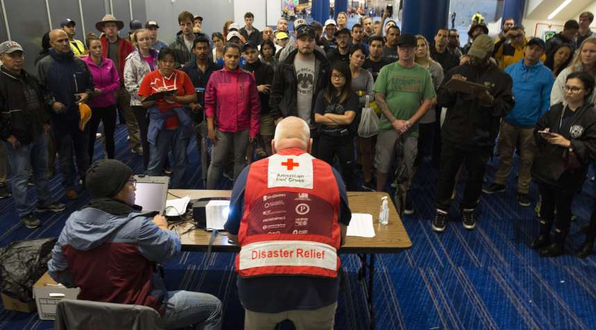 Volunteers get a briefing at the George Brown Convention Center that has been turned into a shelter run by the American Red Cross to house victims of the high water from Hurricane Harvey on August 28, 2017 in Houston, Texas.