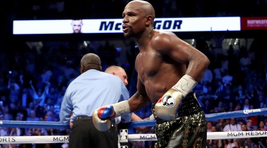 Floyd Mayweather Jr. celebrates a 10th-round TKO of Conor McGregor in their match on Aug. 26 in Las Vegas.