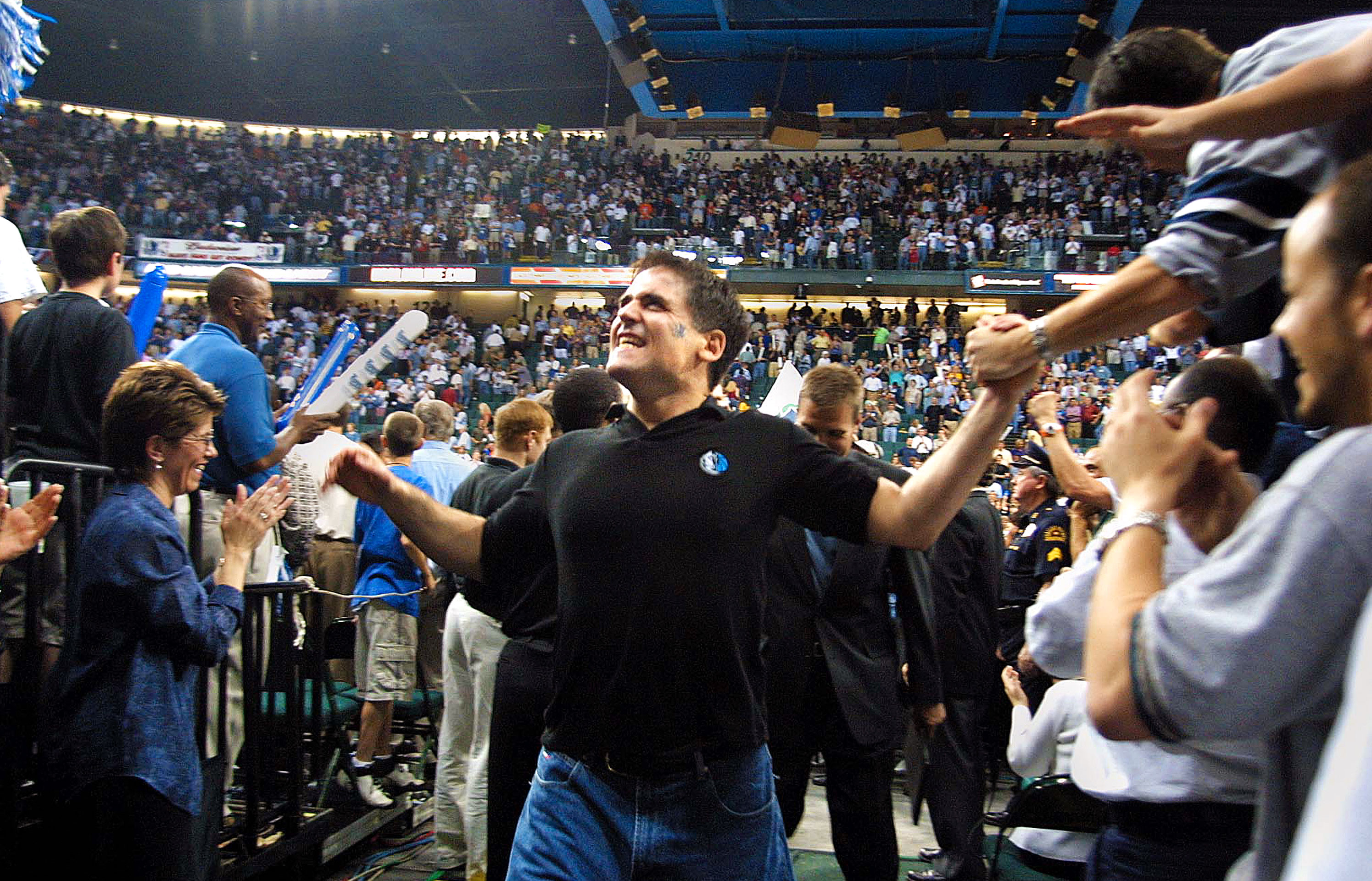 Cuban celebrates with Dallas fans in 2001 following a Mavericks home win over the Utah Jazz.