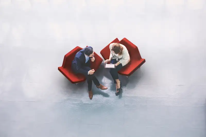 Overhead view of two business persons in the lobby