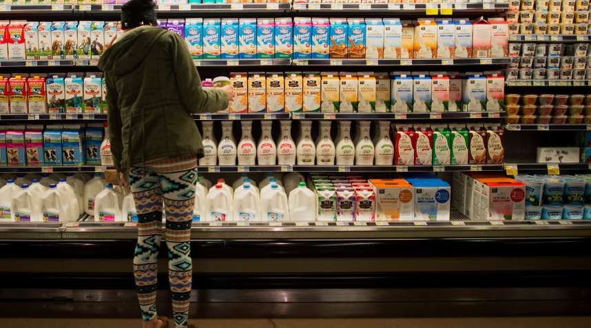 A customer shops in the dairy isle at a Whole Foods Market