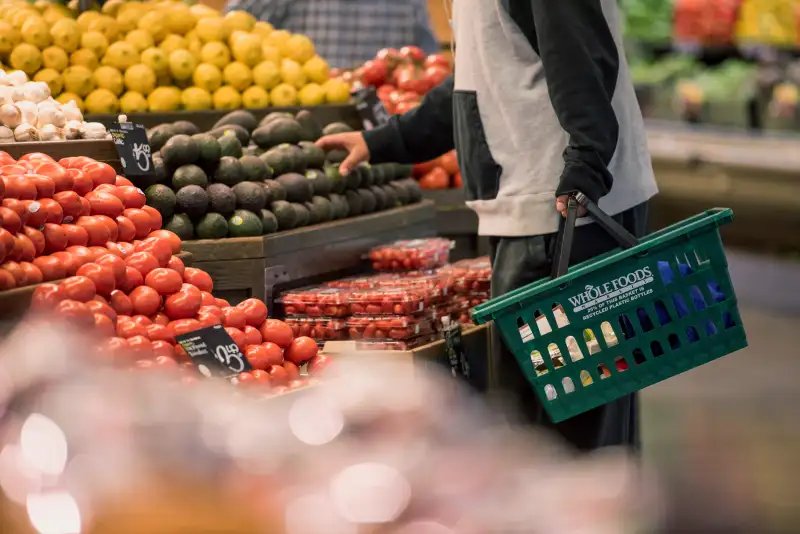 A customer shops for avocados at a Whole Foods Market Inc. store in Oakland, Calif. on May 6, 2015.