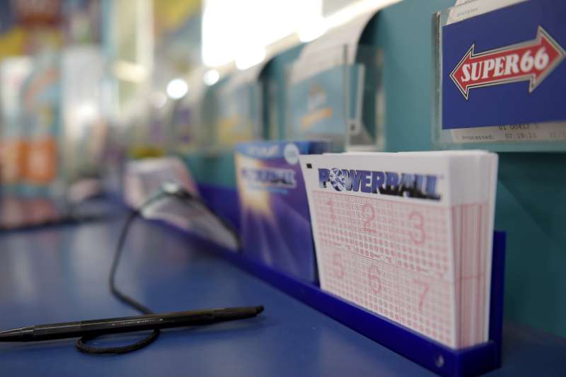 Coupons for Tatts Group Ltd.'s Powerball lottery game sit at a counter at a newsagent's store in Melbourne.