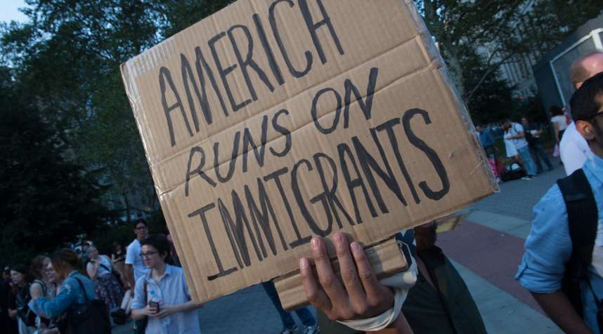 Protesters hold signs at a rally to defend DACA on September 5, 2017, in New York.