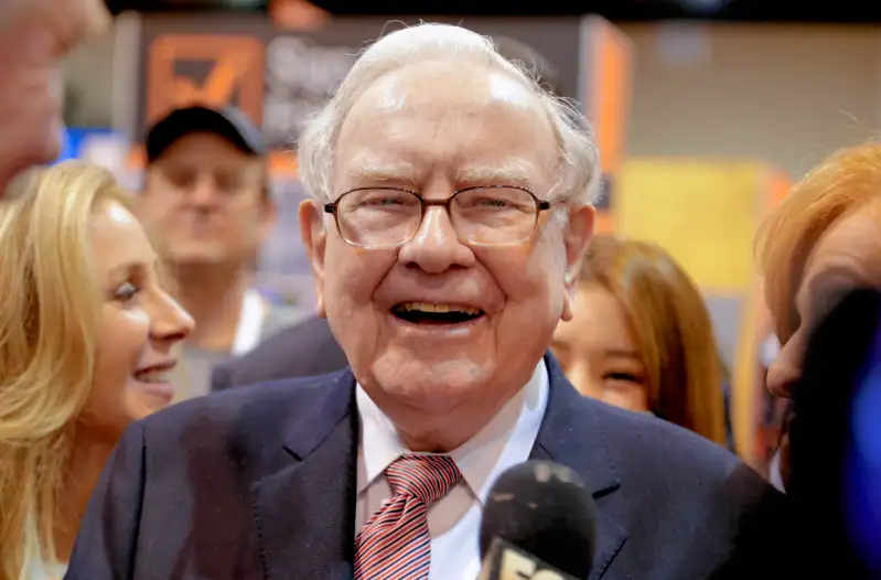 Berkshire Hathaway Chairman and CEO Warren Buffett laughs while touring the exhibit floor at the CenturyLink Center in Omaha, Neb., Saturday, May 6, 2017, where company subsidiaries display their products.