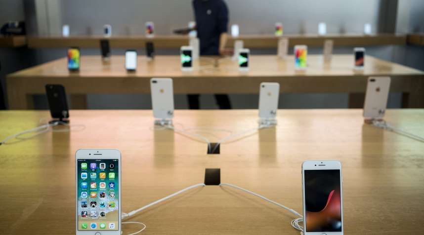 An Apple Inc. iPhone 8 Plus, left, and iPhone 8 stand on display at the Apple Store at Sanlitun during the launch of the devices in Beijing, on September 22, 2017.
