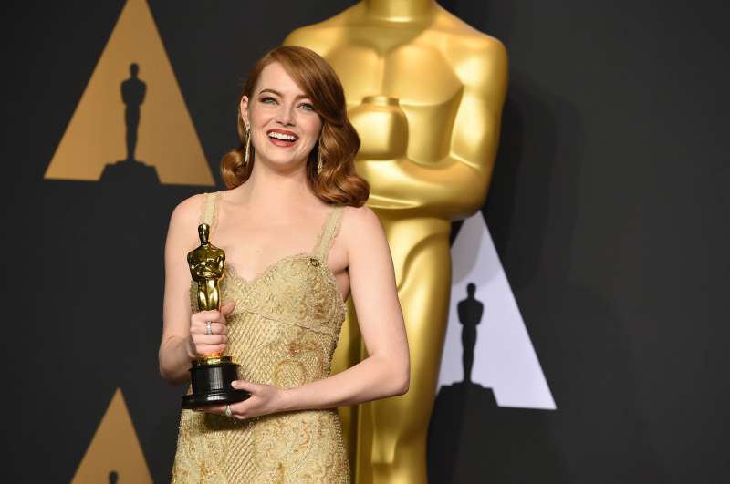 Emma Stone poses in the press room with the award for best actress in a leading role for  La La Land  at the Oscars on Feb. 26, 2017, at the Dolby Theatre in Los Angeles.