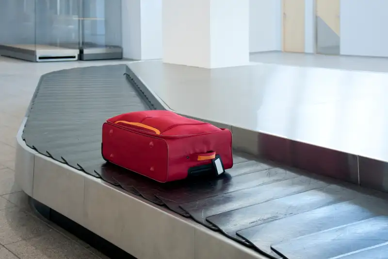 Suitcase on airport conveyor belt