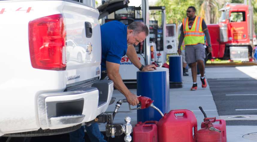 A man fills up gas containers at a Costco Gas Station during preparations for Hurricane Irma in Miami, Florida, September 7, 2017.