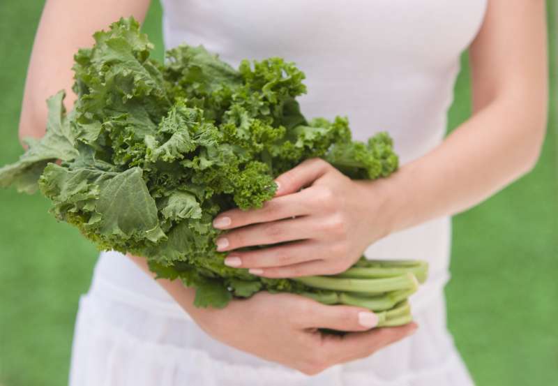 Woman holding fresh kale