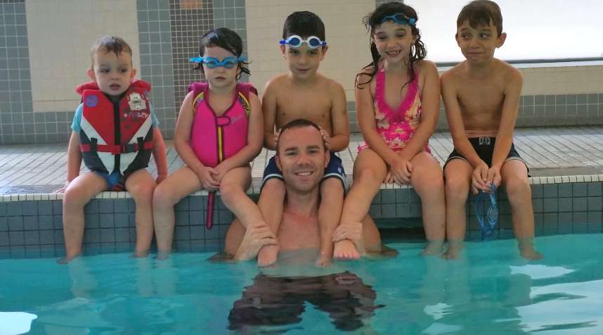 Adrian Crook with his kids in the condo pool.
