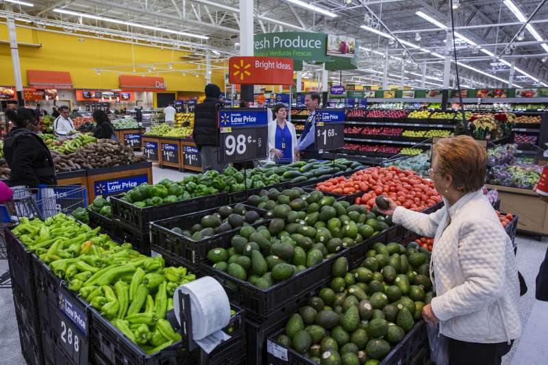 A shopper inspects the fresh produce at a Walmart store in Secaucus, New Jersey