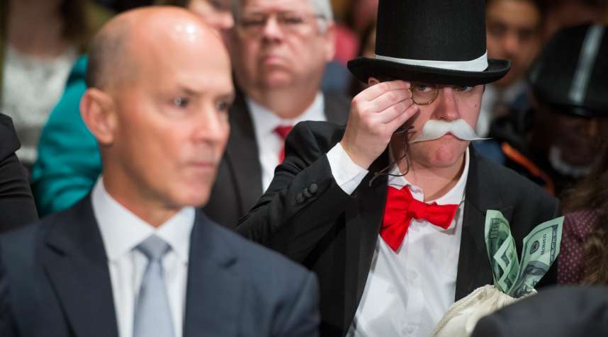 Amanda Werner, who is dressed as Monopoly's Rich Uncle Pennybags, sits behind Richard Smith, left, CEO of Equifax, during a Senate Banking, Housing and Urban Affairs Committee hearing in Dirksen on the company's security breach on Oct. 4, 2017.