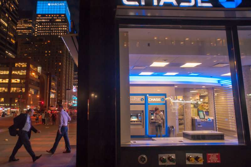 The Barclays sign peeks out behind a JPMorgan Chase bank in Midtown in New York on Tuesday, April 28, 2015. Barclays Plc announced that it will cut investment bank employees in London, New York and Asia to boost earnings and to increase investor confidence. (�� Richard B. Levine) (Photo by Richard Levine/Corbis via Getty Images)