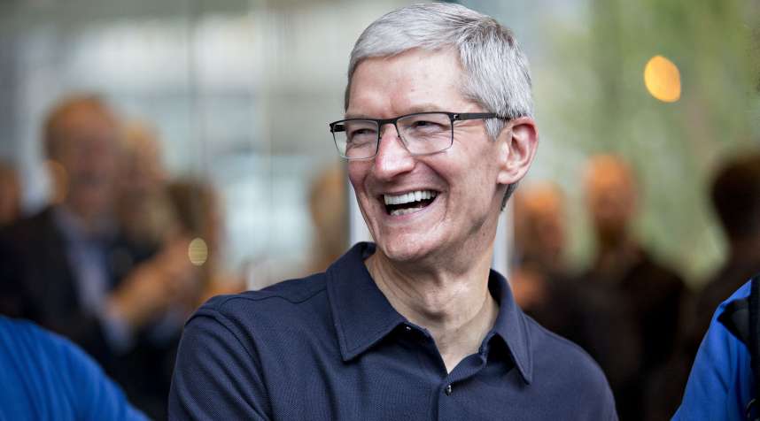 Tim Cook, chief executive officer of Apple, Inc., smiles as he greets customers during the opening of the new Apple Michigan Avenue store in Chicago, Illinois, U.S., on Friday, Oct. 20, 2017. The building features exterior walls made entirely of glass with four interior columns supporting a 111-by-98 foot carbon-fiber roof, designed to minimize the boundary between the city and the Chicago River.
