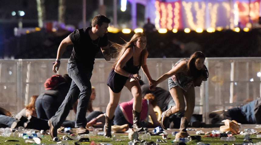 People run from the Route 91 Harvest country music festival after apparent gunfire was heard in Las Vegas on Oct. 1, 2017.