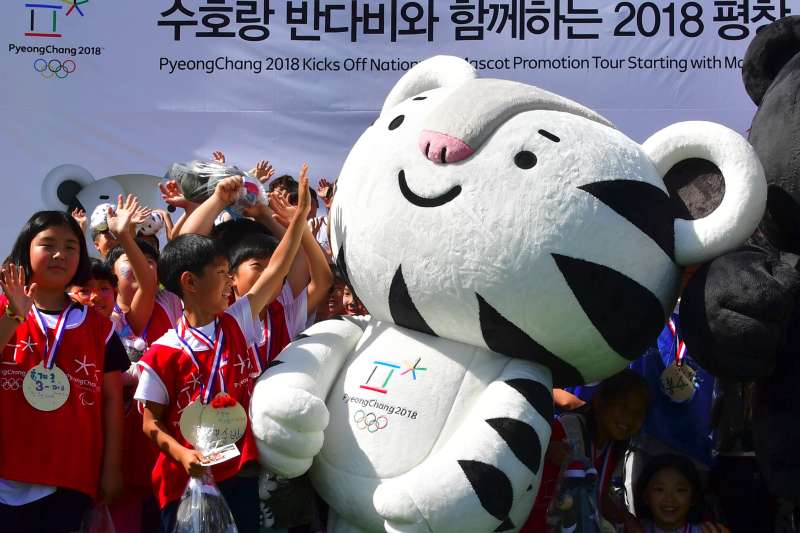 South Korean students react to one of the mascots for the 2018 Pyeongchang Winter Olympics, a white tiger named  Soohorang , during the mascots' first public staging event at Hoenggye elementary school in Pyeongchang, about 150 kms east of Seoul, on July 18, 2016.
            The PyeongChang 2018 Organizing Committee announced a nationwide mascot promotion tour, plus a tour to the Rio Games for more active international promotion as well as a reach to major cities and festivals in South Korea. / AFP / JUNG YEON-JE        (Photo credit should read JUNG YEON-JE/AFP/Getty Images)