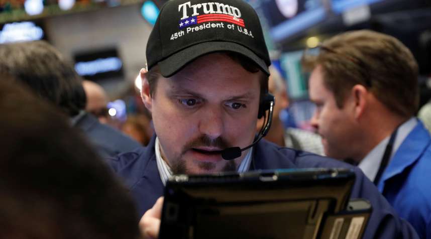 A trader wears a Donald Trump hat while working on the floor of the New York Stock Exchange (NYSE) shortly after the opening bell in New York, U.S., March 16, 2017.