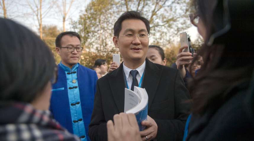 Pony Ma Huateng, center, Chairman of Tencent, is interviewed as he arrives for a forum during the 2nd World Internet Conference, also known as Wuzhen Summit, in Wuzhen town, Tongxiang city, east China's Zhejiang province, December 16, 2015.