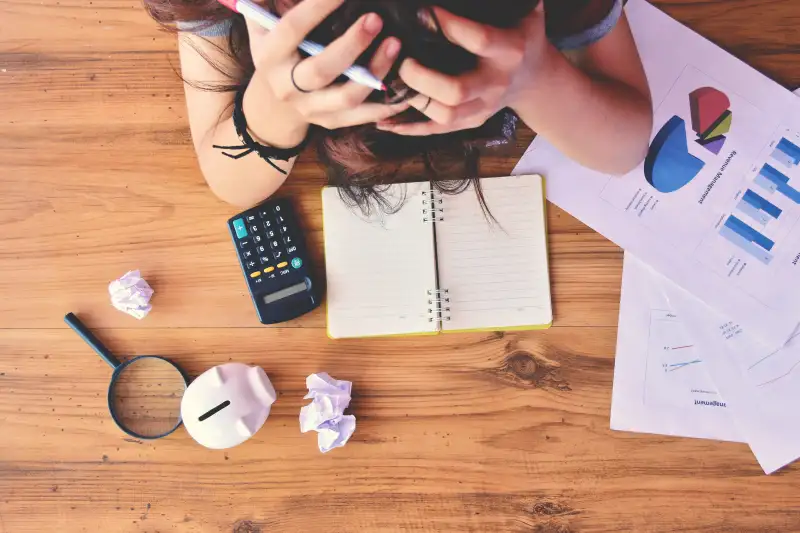 High Angle View Of Frustrated Person Calculating Finances