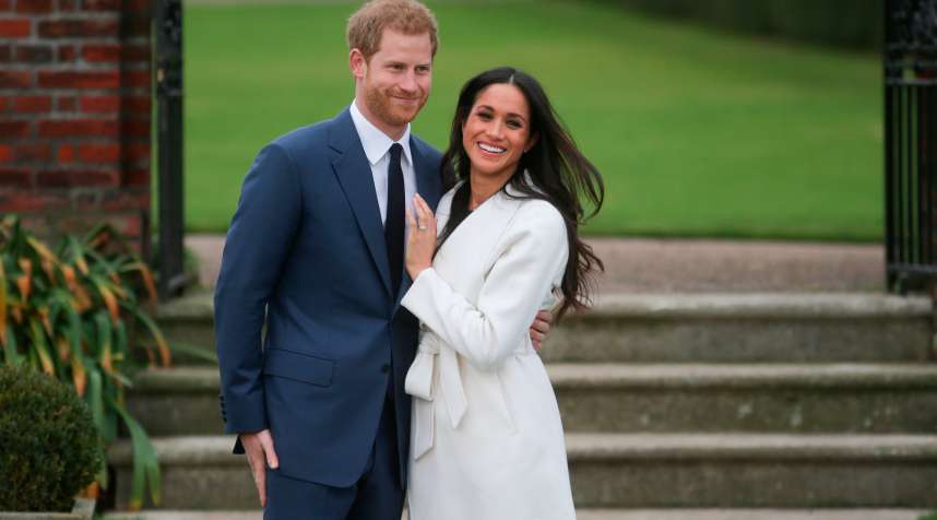 Britain's Prince Harry and his fiancée US actress Meghan Markle pose for a photograph