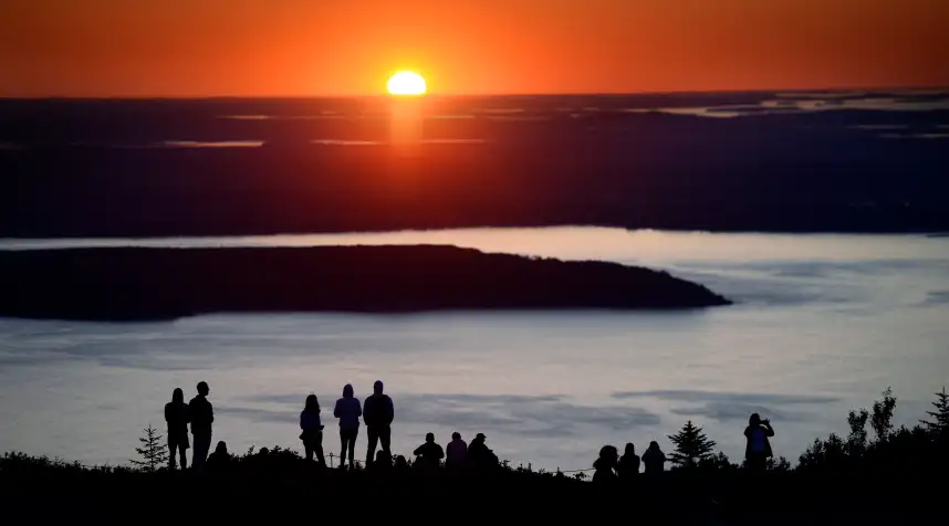 Hundreds of visitors flock to Cadillac Mountain in Acadia National Park to watch the sunrise Monday, July 31, 2017. At 1530 ft. Cadillac Mountain is the tallest mountain along the Eastern Coast of the United States. (Staff photo by Shawn Patrick Ouellette/Portland Press Herald via Getty Images)