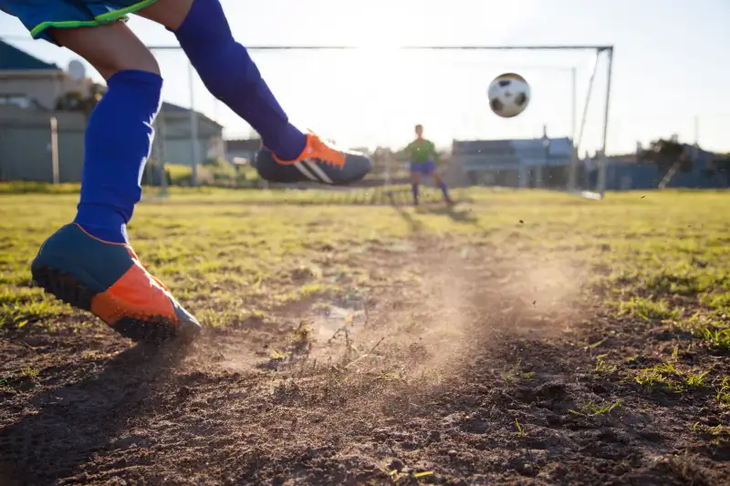 Close up of boy taking soccer penalty