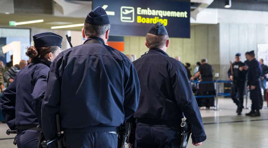 Police officers patrol at Charles de Gaulle airport in Paris, March 22, 2016.