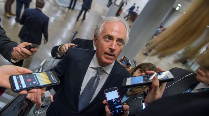 Sen. Bob Corker, R-Tenn., talks with reporters in the basement of the Capitol before the Senate Policy luncheons on December 12, 2017.