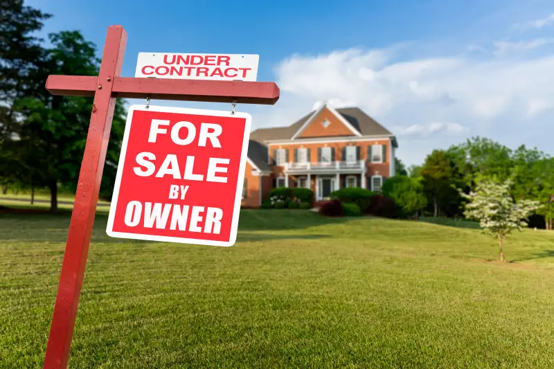 For sale sign in front of large USA home. Image shot 11/2016. Exact date unknown.