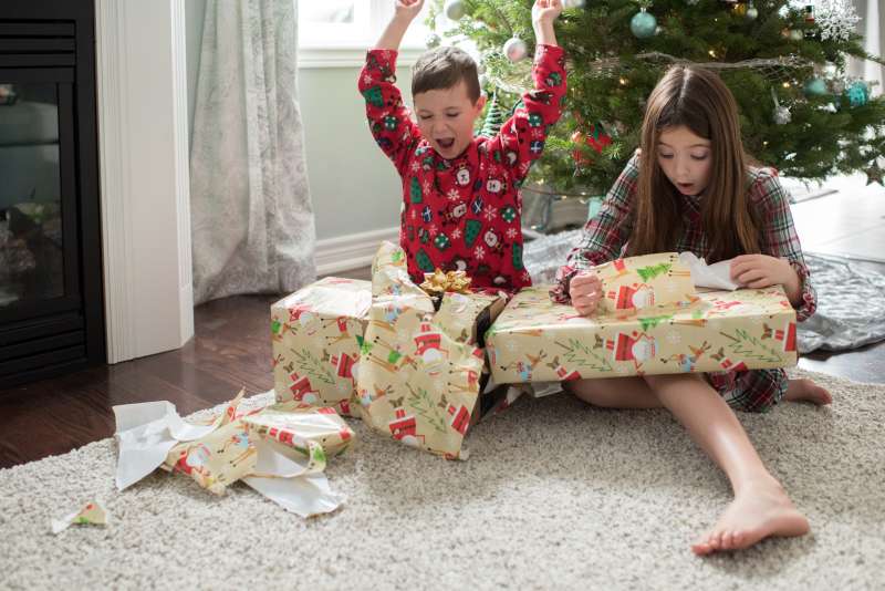 Brother and sister opening christmas presents