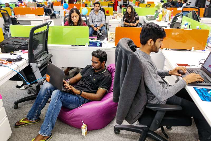 India's growth is a key long-term global trend to watch. Here, employees work on their laptops at Xiaomi Corp. headquarters in Bengaluru, India.