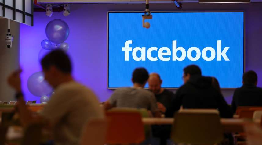 Employees have lunch at the canteen at Facebook's new headquarters in central London on December 4, 2017.