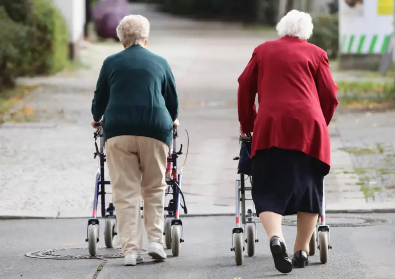 Two German women walking along driveway