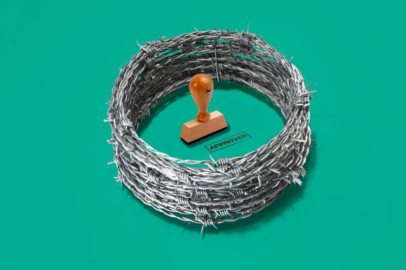 Approved stamp surrounded by a ring of barbed wire