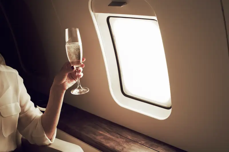 Businesswoman relaxing aboard private jet