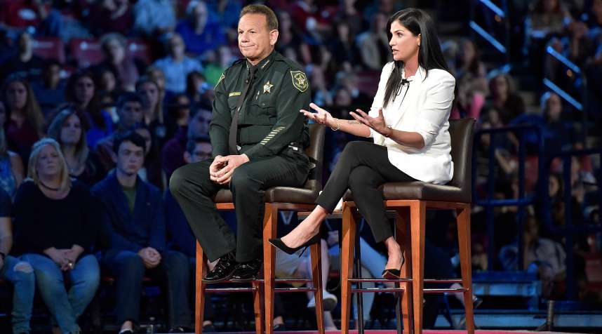 NRA spokesperson Dana Loesch answers a question while sitting next to Broward Sheriff Scott Israel, during a CNN town hall in Florida.