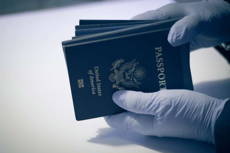 Unrecognizable person, having american passport for inspection