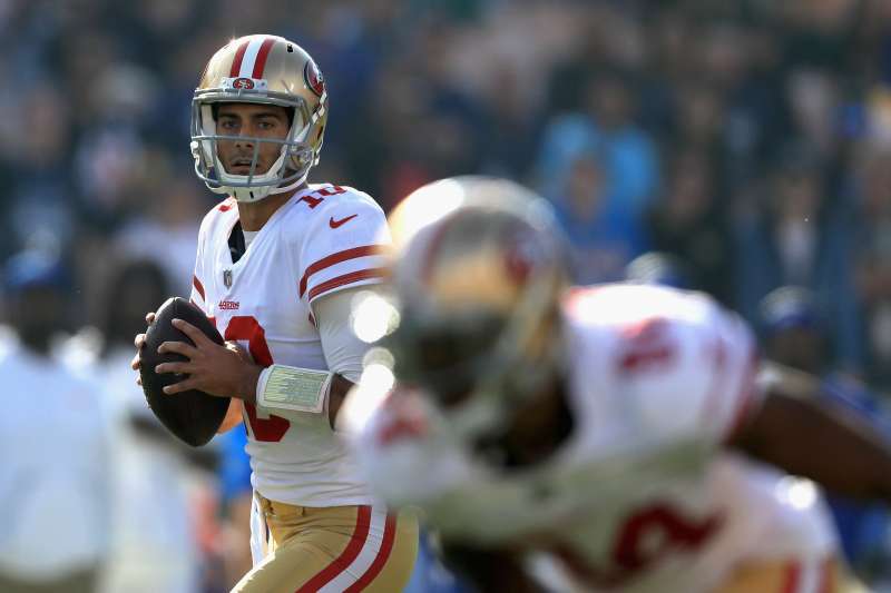 Jimmy Garoppolo #10 of the San Francisco 49ers looks to pass during the first half of a game against the Los Angeles Rams  at Los Angeles Memorial Coliseum on December 31, 2017 in Los Angeles, California.