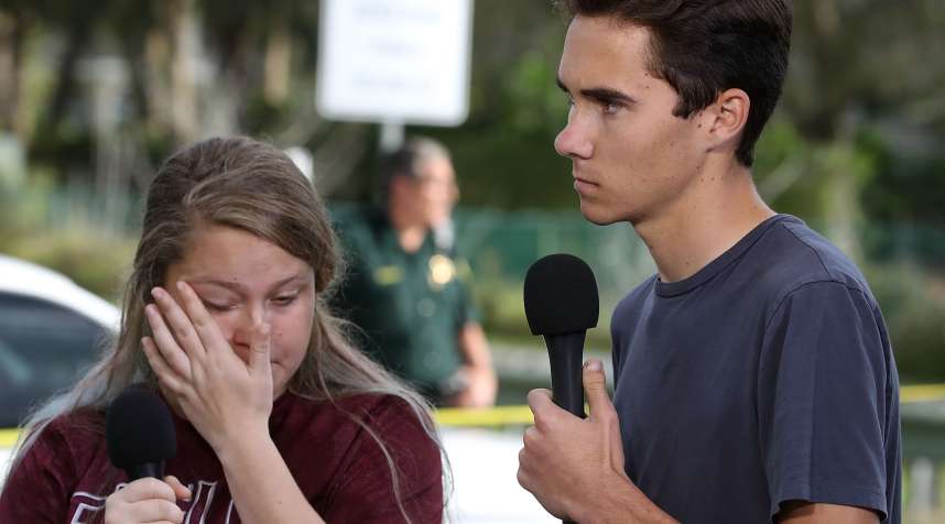 PARKLAND, FL - FEBRUARY 15: Students Kelsey Friend (L) and David Hogg recount their stories about yesterday's mass shooting at the Marjory Stoneman Douglas High School where 17 people were killed, on February 15, 2018 in Parkland, Florida. Police arrested the suspect after a short manhunt, and have identified him as 19 year old former student Nikolas Cruz.  (Photo by Mark Wilson/Getty Images)