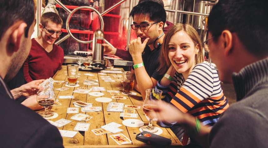 Beer drinkers play cards at Aeronaut Brewing.