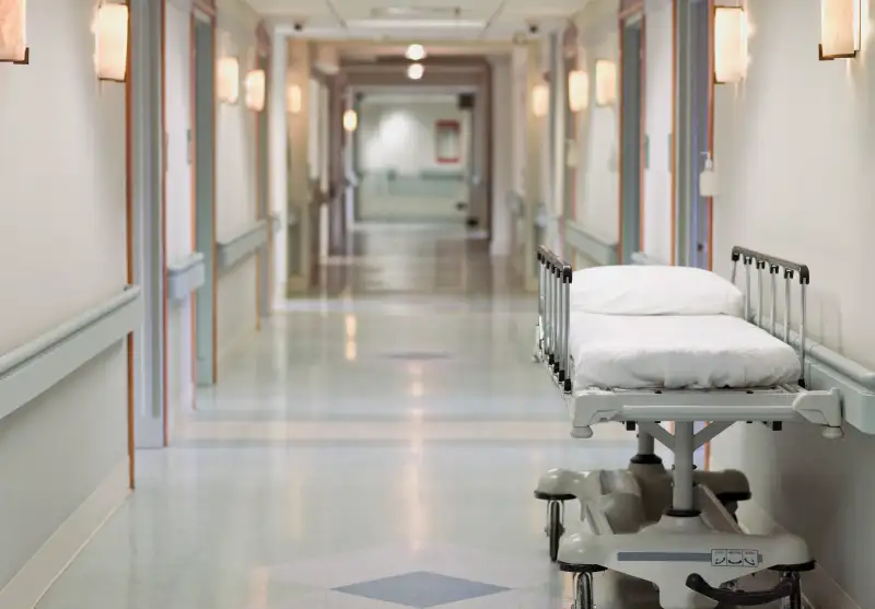 Portable hospital bed in hallway