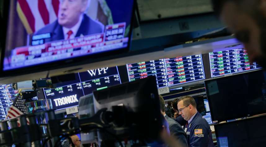 Traders work on the floor of the New York Stock Exchange (NYSE) as U.S. President Donald Trump is seen on TV on March 1, 2018 in New York City. Major stock indexes plunged Thursday afternoon following President Trump's announcement that he was imposing a 25 percent tariff on imported steel and 10 percent on aluminum. Investor concern about the news rattled the Dow Jones industrial average, which closed down more than 400 points.