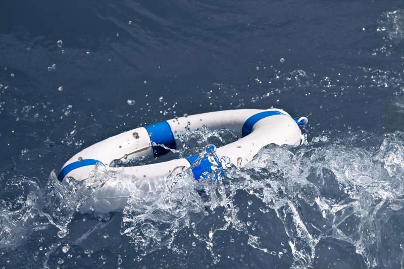 Lifebuoy, lifebelt, life saver in a storm wave as help