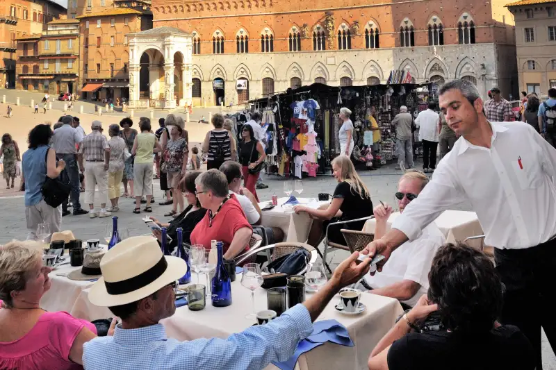 Tourists in cafe on Piazza del Campo