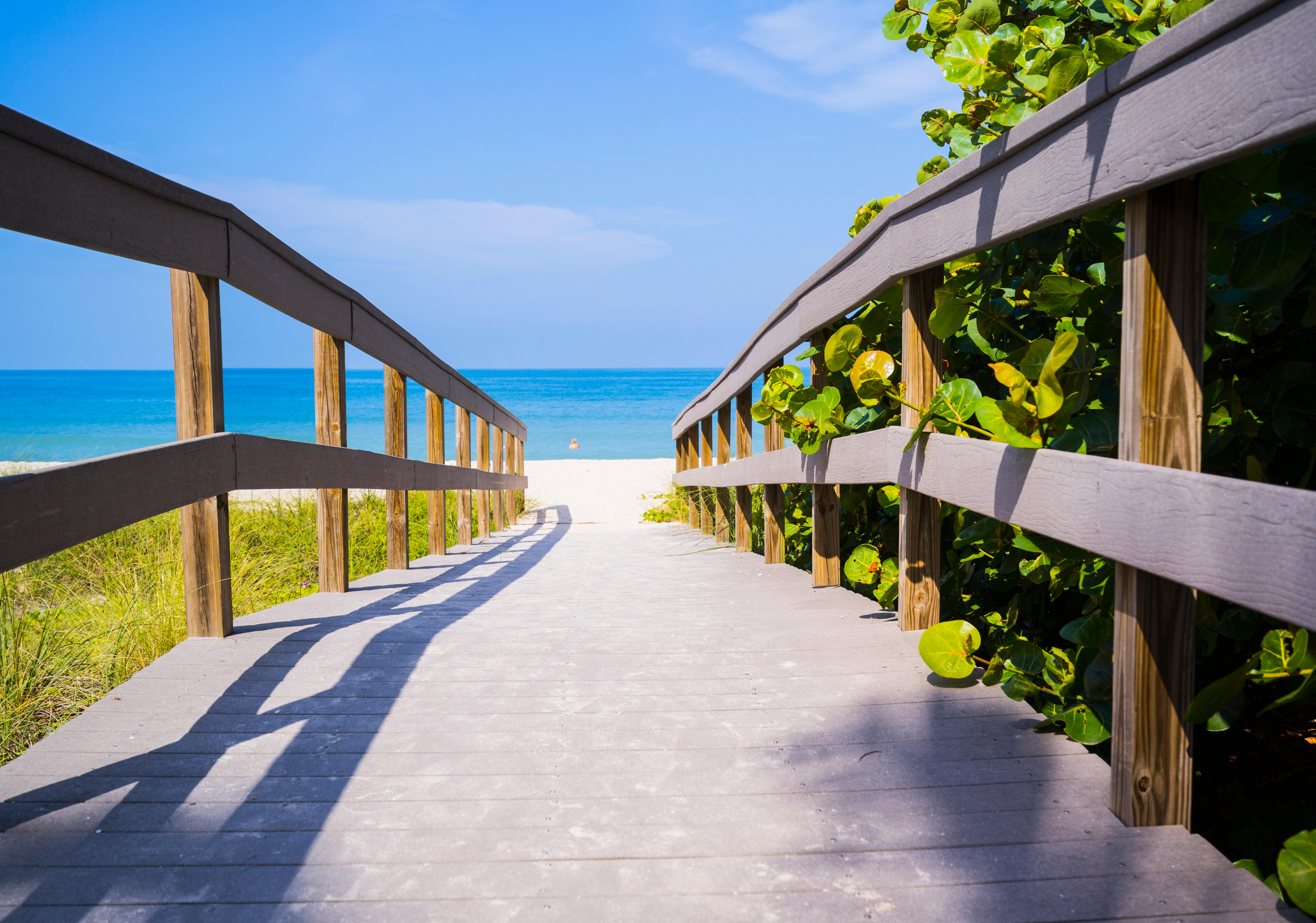 Florida, USA - Wooden boardwalk to ocean on Sunset Beach, Treasure Island, Florida on Gulf of Mexico in summer