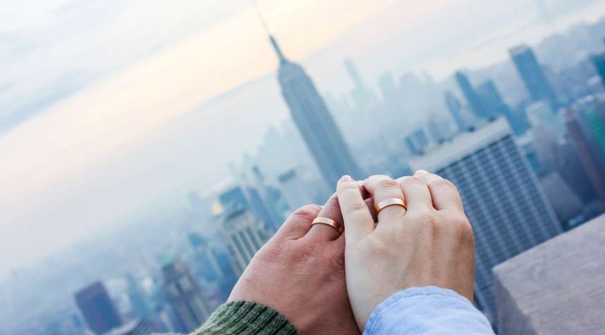Hands of a married couple with rings in New York City, USA.