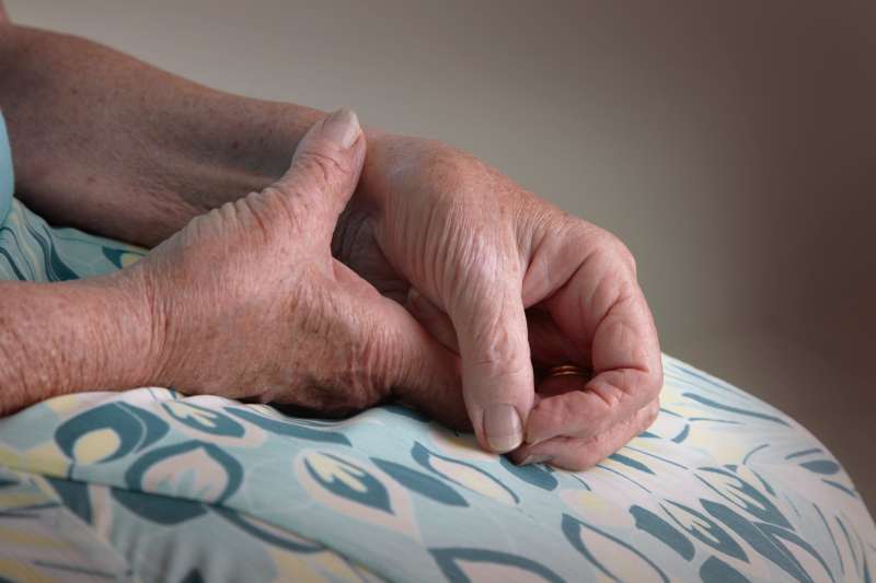 Senior woman rubbing a sore arthritic wrist