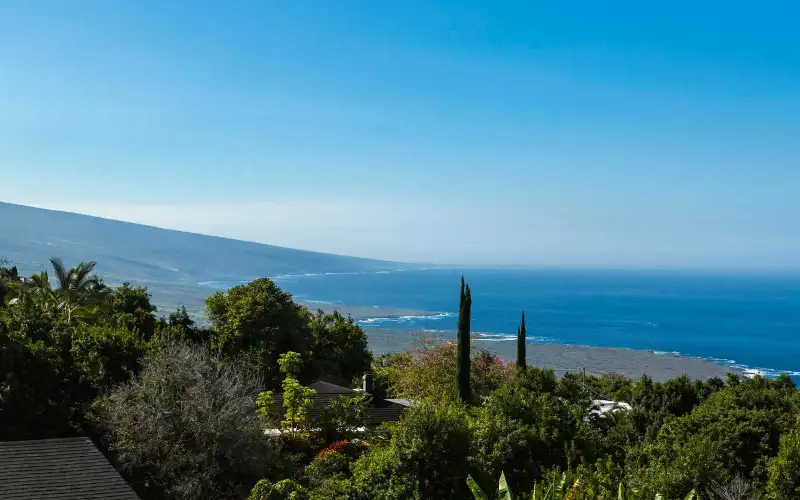 View to South Kona coastline and Mauna Loa rising from the ocean